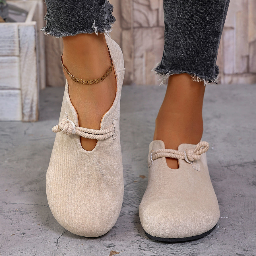 Beige matte fabric round toe flats with cord detail and a cutout.