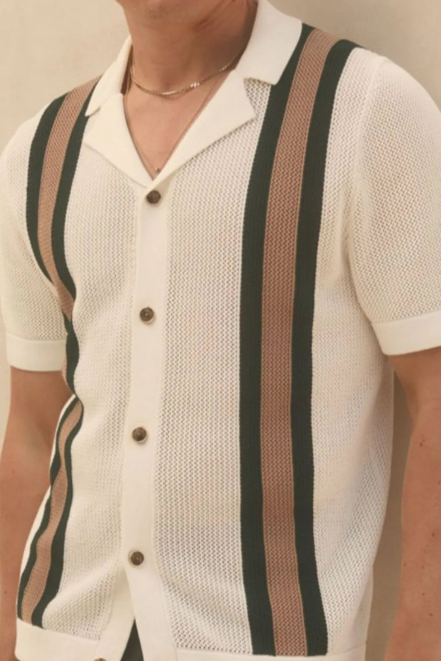 Ivory knit polo shirt with vertical stripe detail and button front