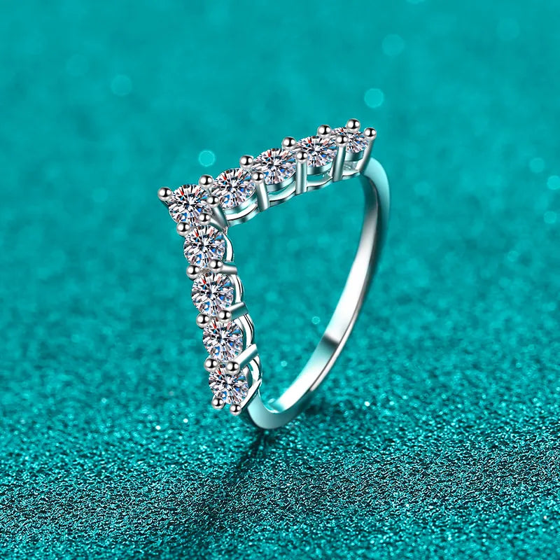 Chevron moissanite cluster ring in silver with a V-shaped band of sparkling stones.