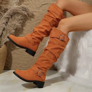 Slouchy knee-high boots in terracotta with buckle detail and flat heel.