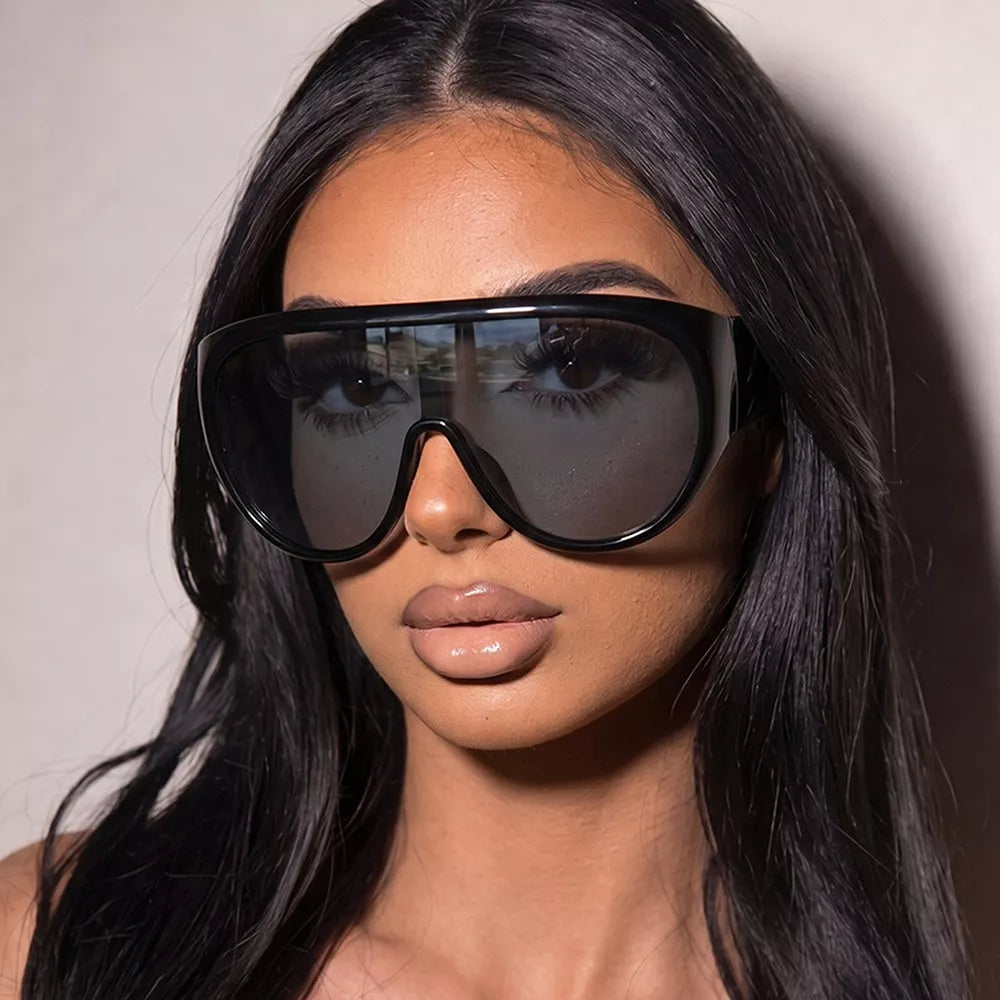 sunglasses in black featuring UV protection and oversized fit