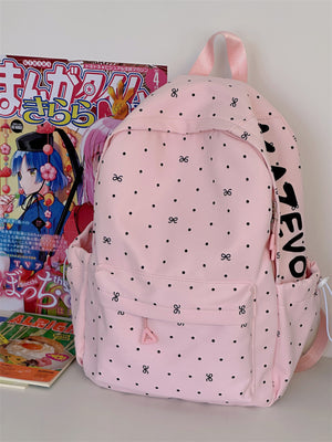Pink polka dot backpack with bowknot pattern and front zipper pocket.