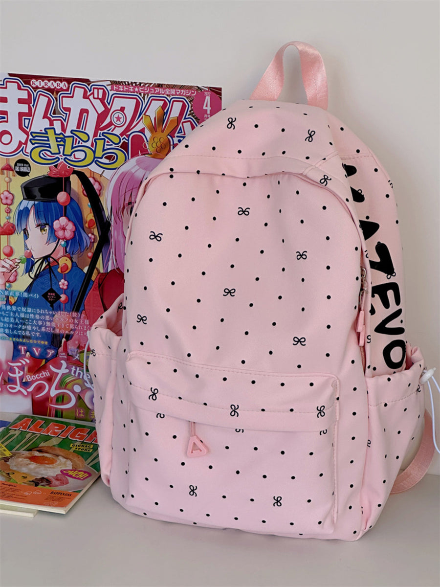 Pink polka dot backpack with bowknot pattern and front zipper pocket.