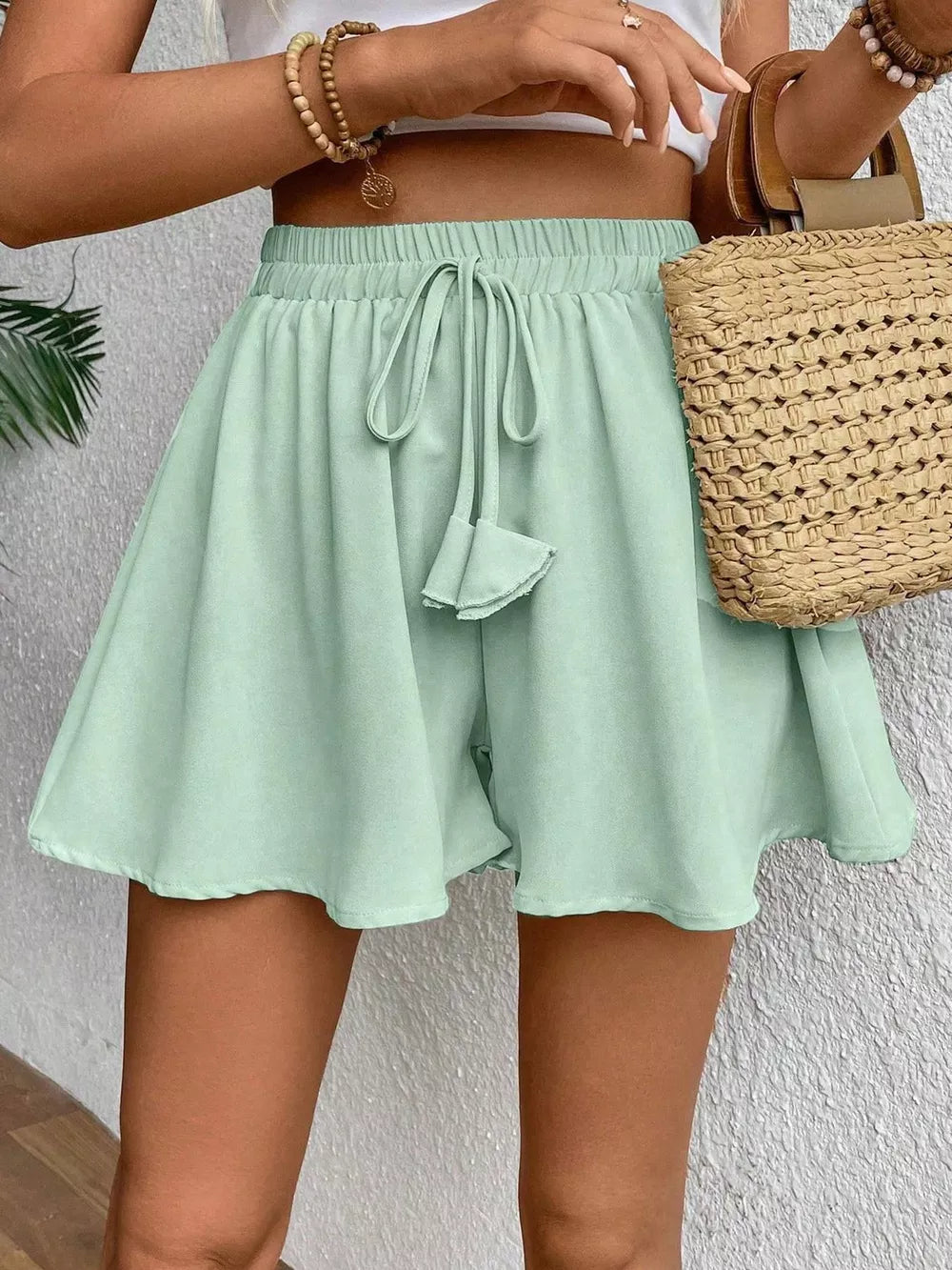 Green cotton chino shorts with drawstring waist and A-line cut.