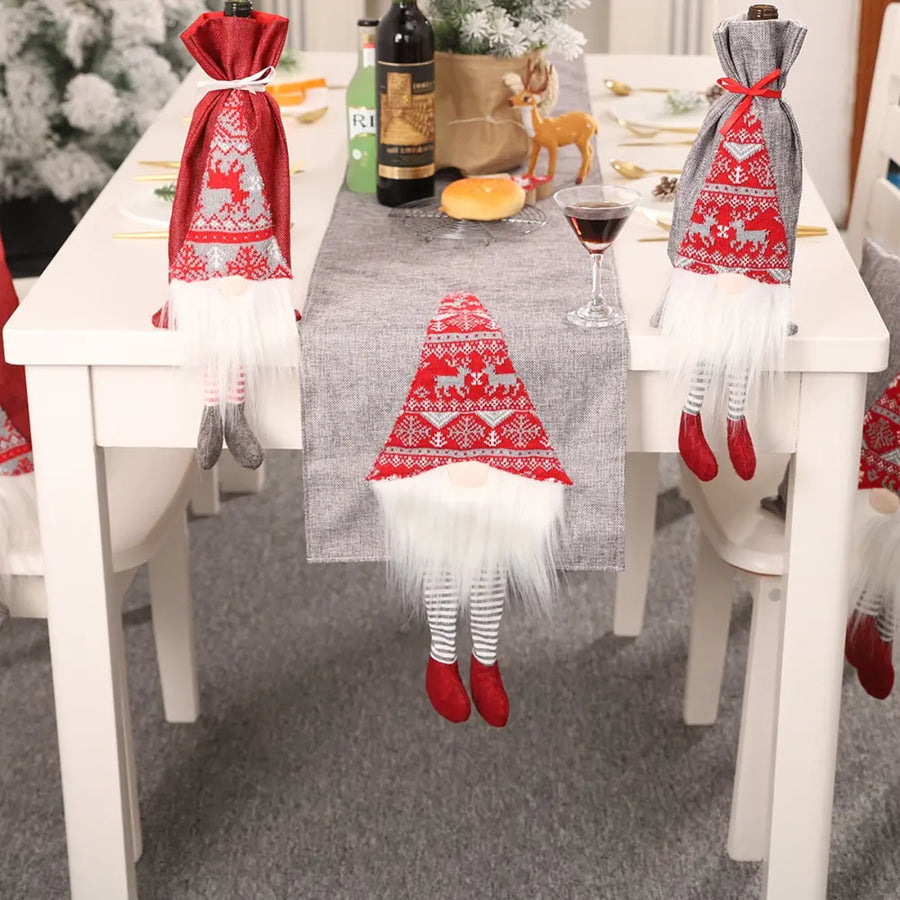 Table runner with three gnome accents in red and gray with reindeer and snowflake patterns.