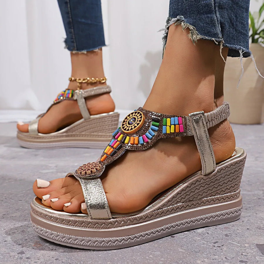 Gold embellished platform wedge sandals with colorful beads and woven wedge detail.