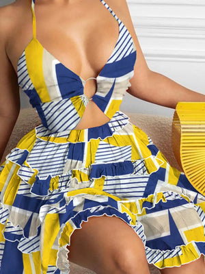 Halter mini dress with abstract print, cutout, and ruffled hem in yellow and blue.