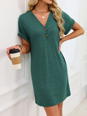 Dark green t-shirt dress with V-neck, decorative buttons, and cuffed short sleeves.