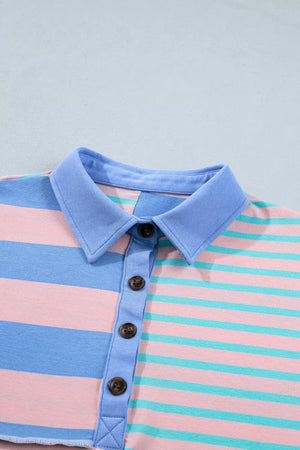 Striped polo shirt in pink, blue, and teal with a blue collar and button placket.