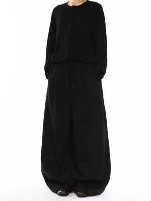 Men's black wide-leg drawstring sweatpants with pockets.