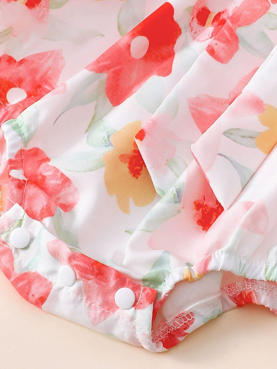 Floral print baby bodysuit with white snap closures and matching headband detail.