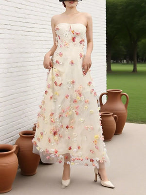 Strapless ivory tulle maxi dress with floral appliques and sweetheart neckline.