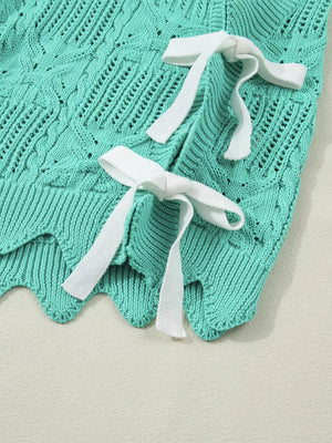 Pointelle knit sweater in teal with white tie details and scalloped trim.