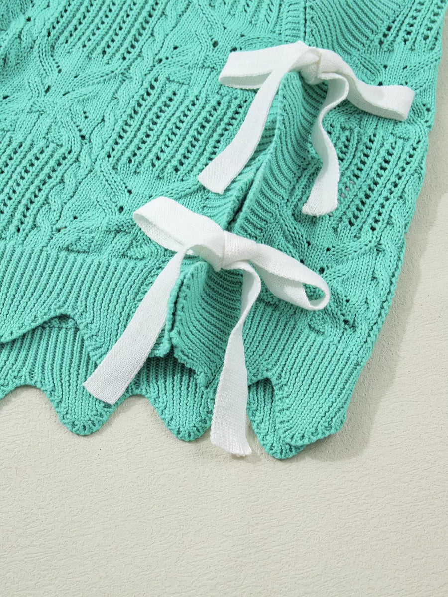 Pointelle knit sweater in teal with white tie details and scalloped trim.