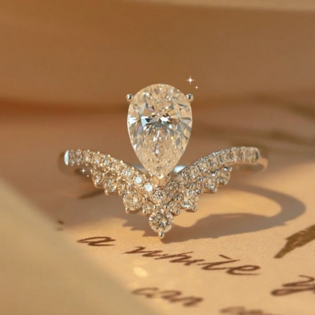 ring in silver featuring pear-cut stone and V-shaped band with pear-cut stone fit