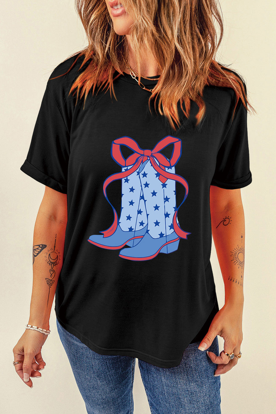 Black t-shirt with cowboy boot and bow graphic, featuring blue boots with stars and a red bow.