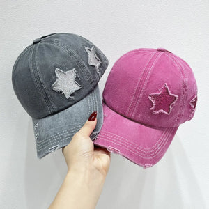 Stellar snapback cap in hot pink and gray with distressed star patches and frayed brim.