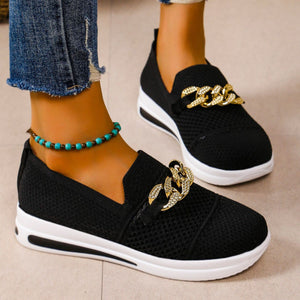 Black mesh slip-on flats with chunky gold chain detail and white soles.