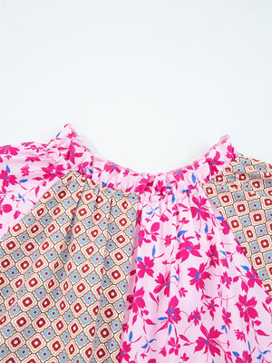 Boho floral print blouse in fuchsia pink with geometric pattern detail and ruffled neckline.