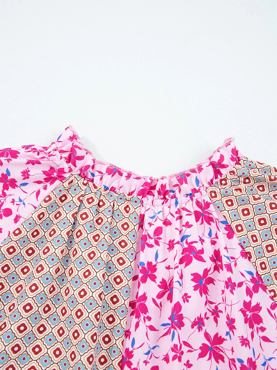 Boho floral print blouse in fuchsia pink with geometric pattern detail and ruffled neckline.
