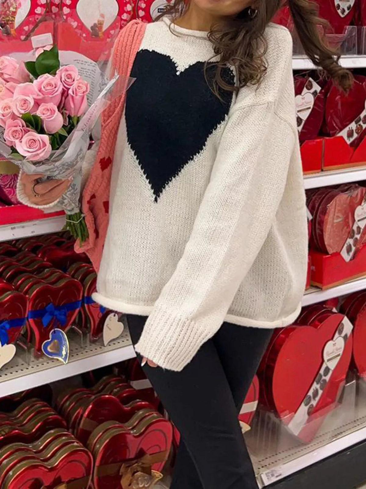 White acrylic blend sweater with dropped shoulders and a black heart print.