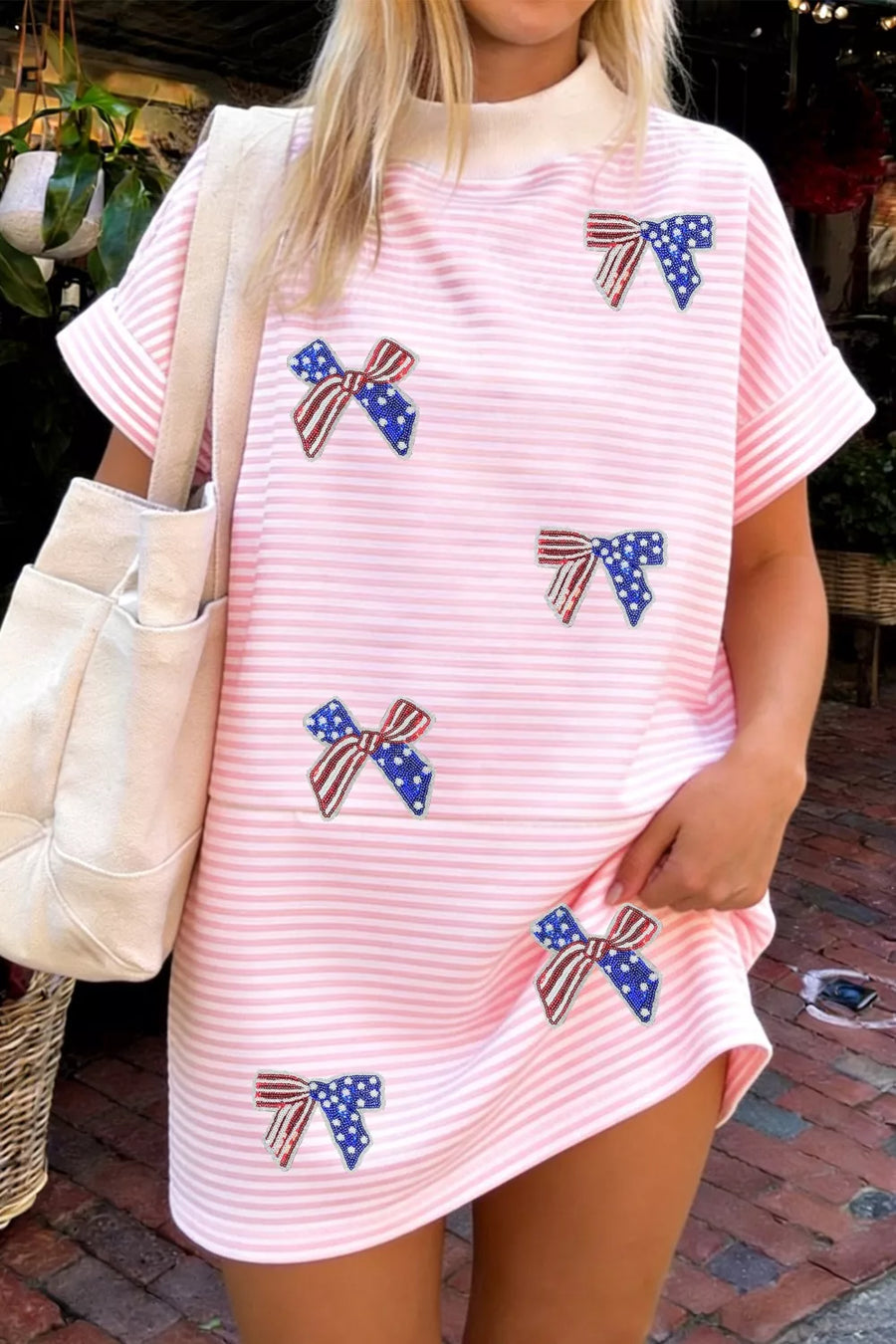 Pink striped mini dress with American flag bows, short sleeves, and mock neck.