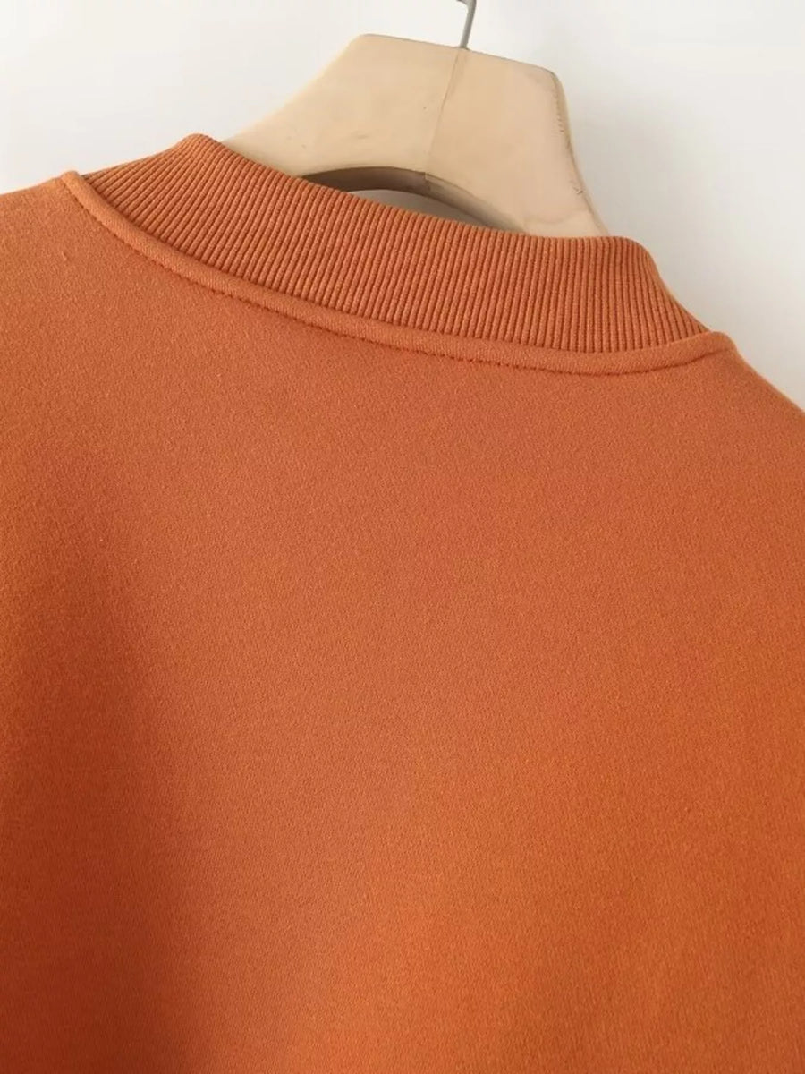 Orange casual zip-up top with ribbed mock neck detail