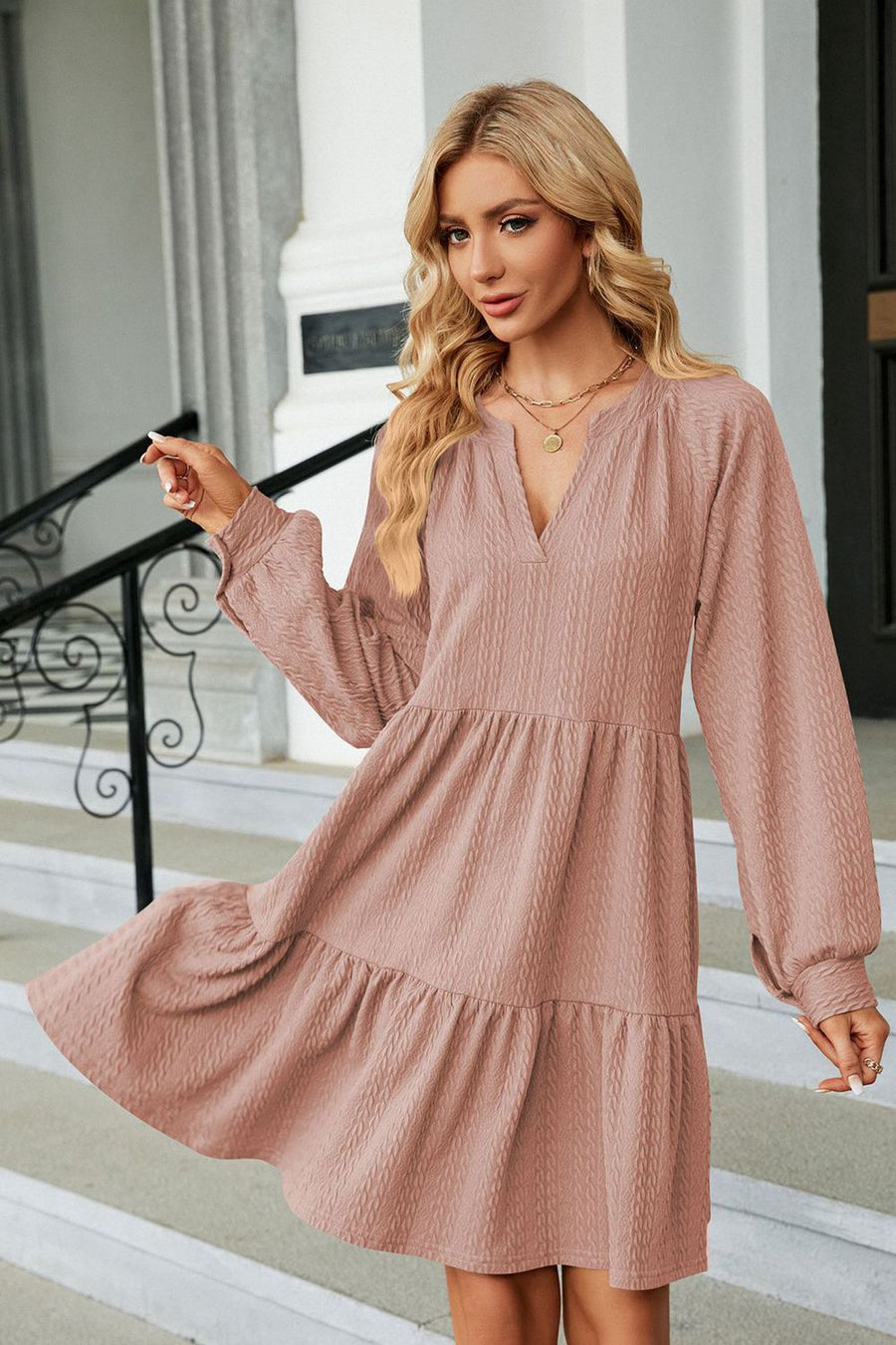 Dusty Pink textured babydoll mini dress with voluminous sleeves and tiered skirt.