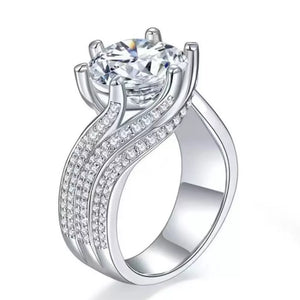 Exquisite Moissanite solitaire ring in silver with pave diamond band.