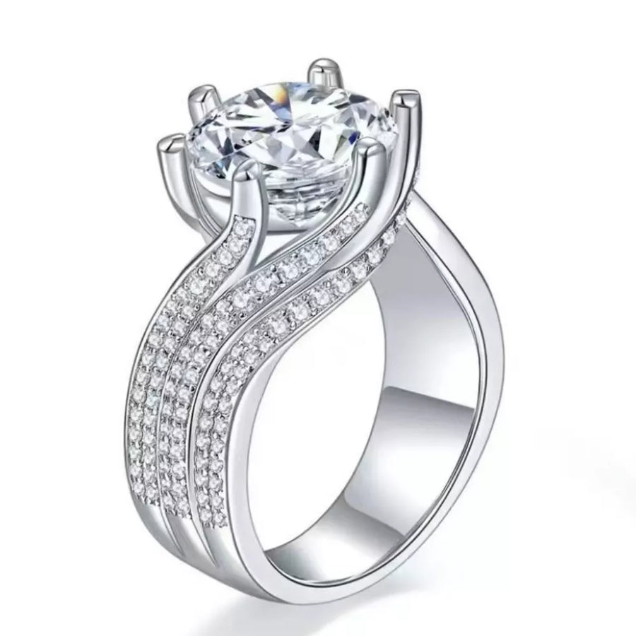 Exquisite Moissanite solitaire ring in silver with pave diamond band.