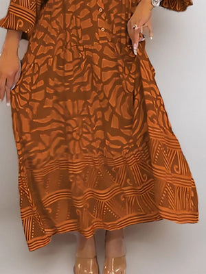 Brown abstract print midi dress with button detail and tiered hem.