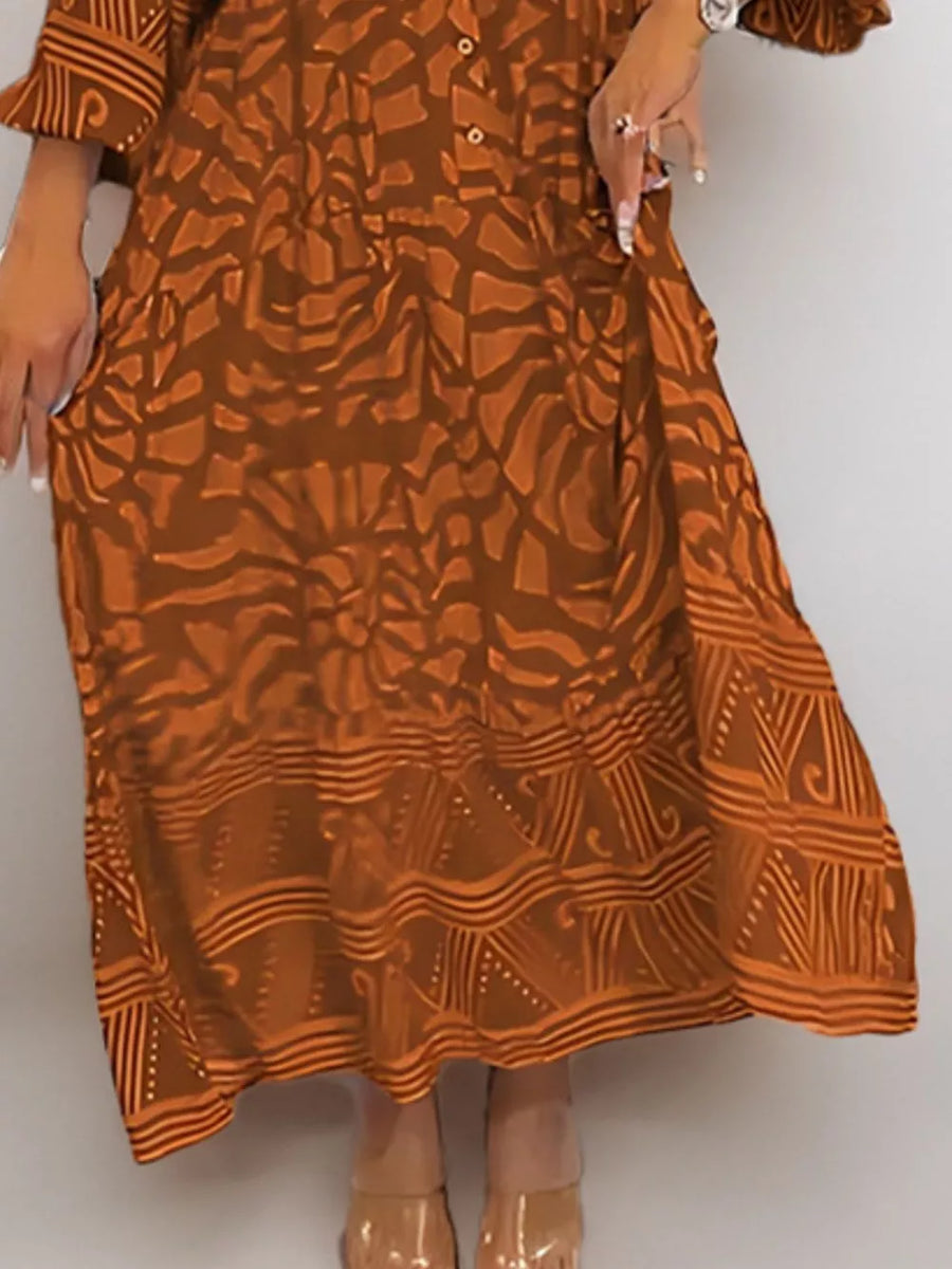 Brown abstract print midi dress with button detail and tiered hem.