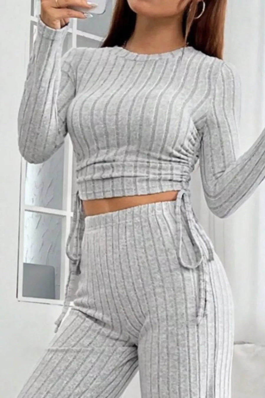 Light gray ribbed knit crop top with drawstring sides and matching wide-leg pants.