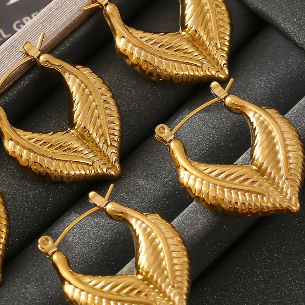 Textured gold leaf hoop earrings with 18K gold plating.