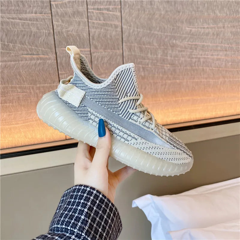 Textured knit platform sneakers in light gray with white accents and a translucent sole.