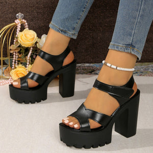 Black two-tone open-toe block heel sandals with chunky platform sole and ankle strap.