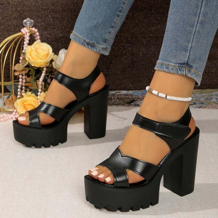 Black two-tone open-toe block heel sandals with chunky platform sole and ankle strap.