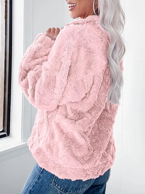 Pink textured fleece quarter zip sweatshirt with a cozy feel.