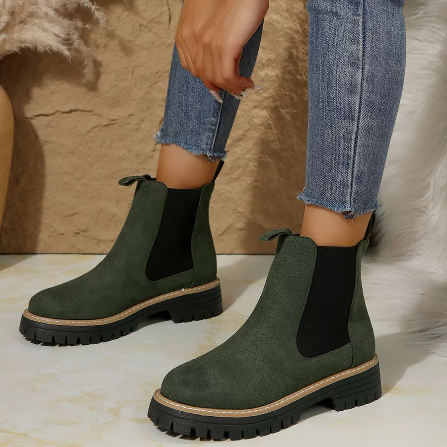 Green suede platform ankle boots with chunky sole and elastic side panels.