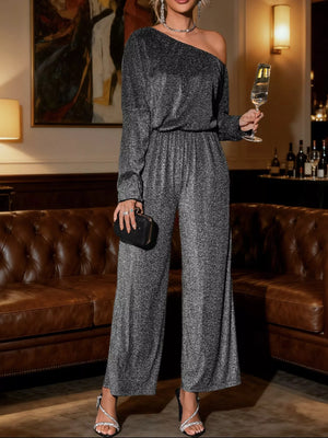 One shoulder glitter jumpsuit in gray with wide legs and long sleeves.