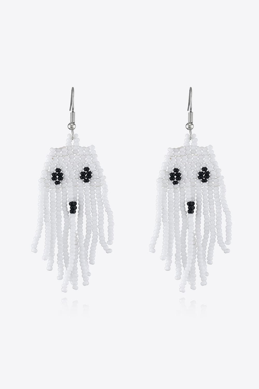 White beaded ghost fringe earrings with black bead eyes and mouth.