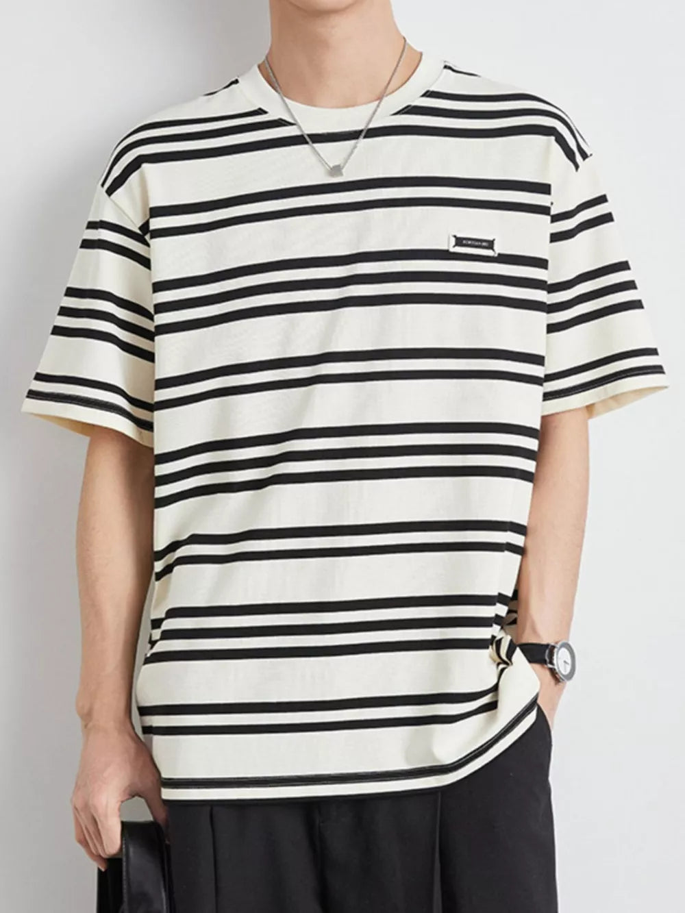 Men's striped cotton crew neck tee in apricot with black horizontal stripes.