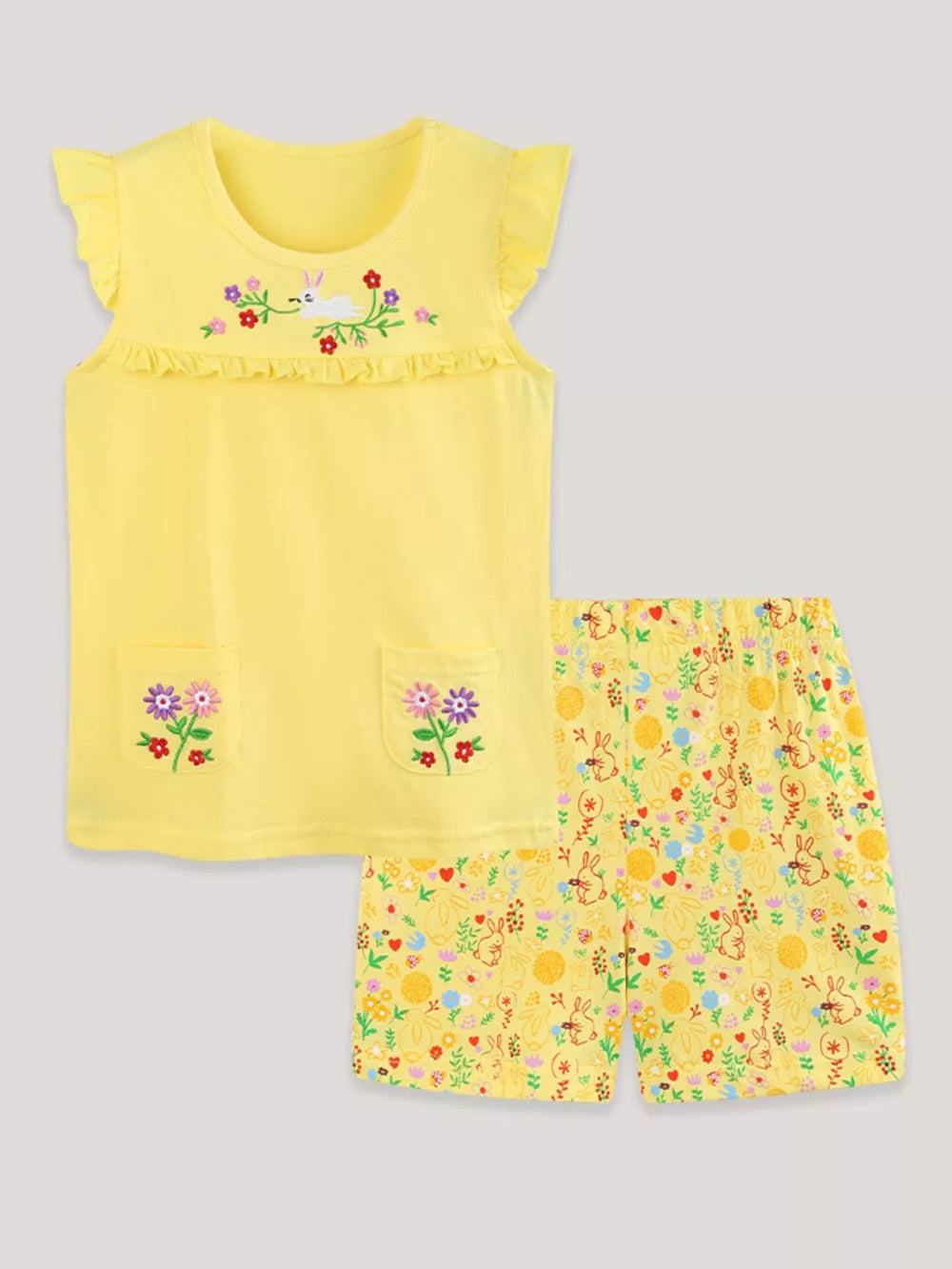 Yellow cotton toddler undershirt with ruffled sleeves and floral embroidery, paired with bunny and floral print shorts.