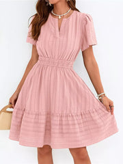 Pink textured V-neck tiered dress with short sleeves and smocked waist