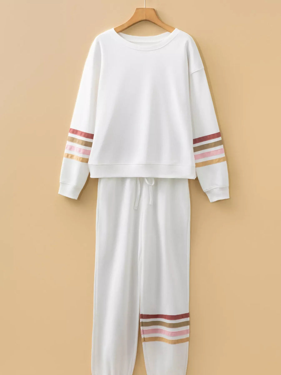 White loungewear set with striped sleeves and hem detail.