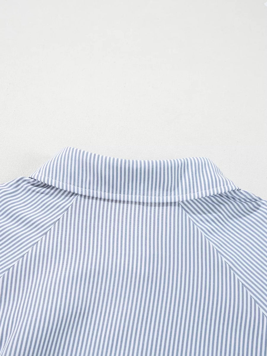 Striped button-up shirt with a pointed collar and long sleeves.