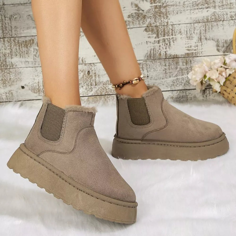 Beige suede round toe platform ankle boots with faux fur trim and elastic gore.