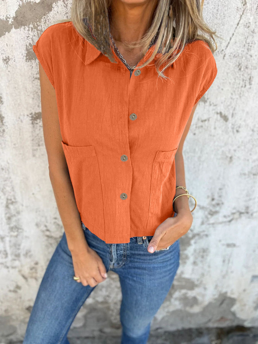 Orange button-down cap sleeve shirt with two chest pockets and a cropped fit.