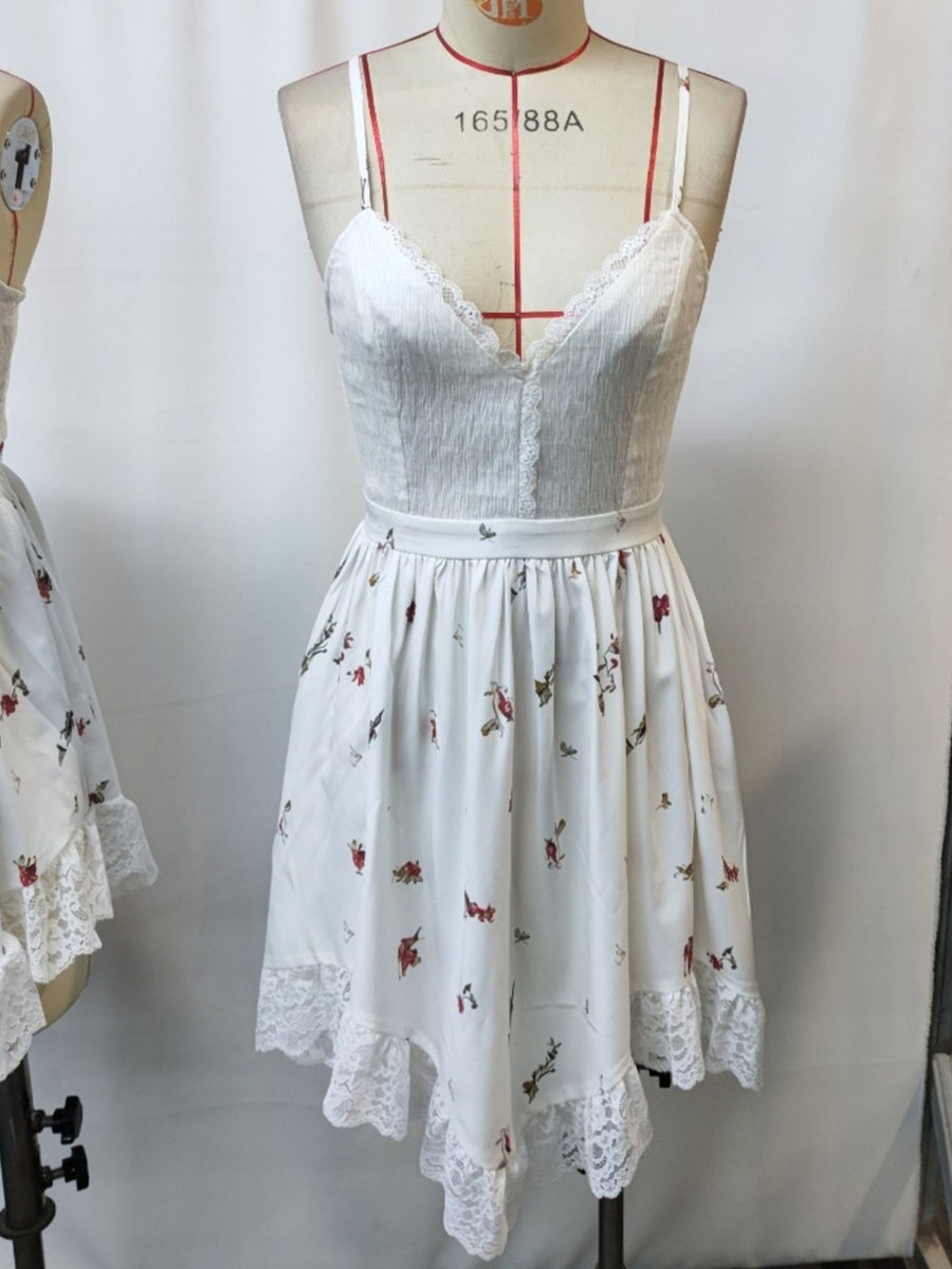 White floral print cami dress with lace trim and spaghetti straps.
