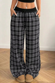 wide-leg pants in black featuring drawstring waist and loose fit